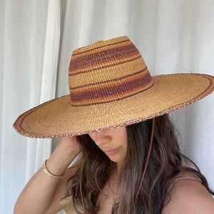 Vintage one of a kind straw hat with thin leather strap.